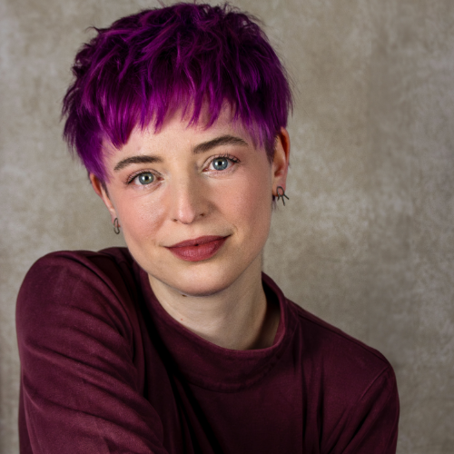 Emily VHS, a white woman in her 30s with short fushia hair